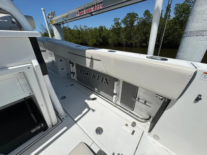  Yacht Photos Pics 2021 Blackfin 272 CC boat interior with sleek seating and storage compartments.