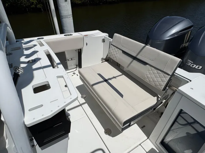  Yacht Photos Pics 2021 Blackfin 272 CC boat interior with seating and dual outboard engines.