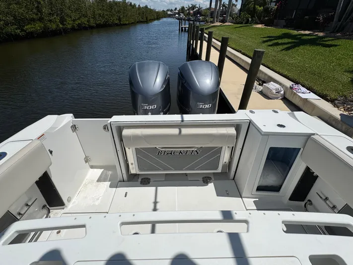  Yacht Photos Pics 2021 Blackfin 272 CC boat with dual 300 engines docked by a canal.