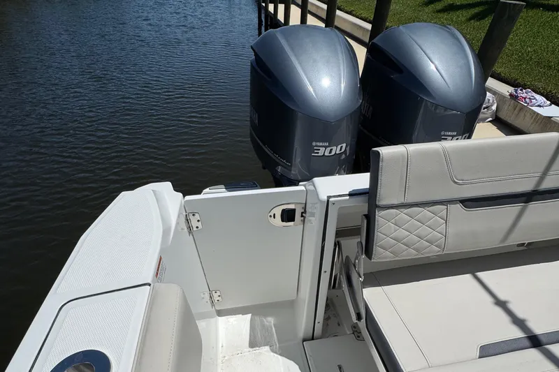  Yacht Photos Pics 2021 Blackfin 272 CC boat with twin outboard engines docked by the water.