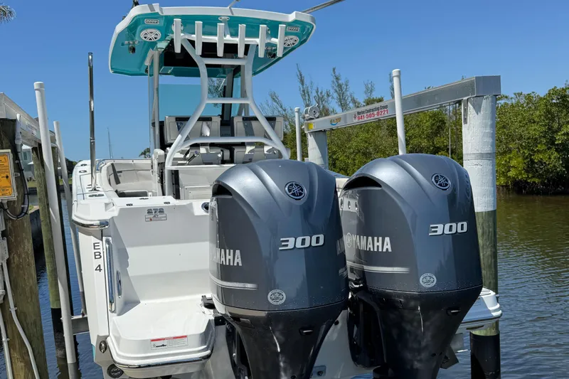  Yacht Photos Pics 2021 Blackfin 272 CC boat with dual Yamaha 300 engines docked by the water.