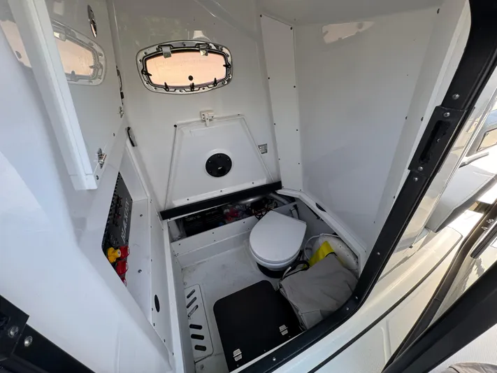  Yacht Photos Pics Interior of 2021 Blackfin 272 CC boat cabin with toilet and storage space.