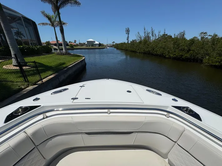  Yacht Photos Pics Bow view of 2021 Blackfin 272 CC boat on a calm waterway.