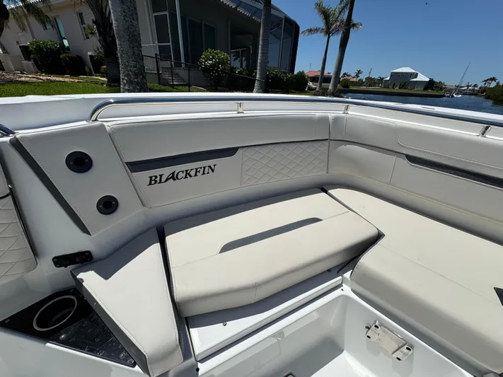  Yacht Photos Pics 2021 Blackfin 272 CC boat interior with white cushioned seating and logo.