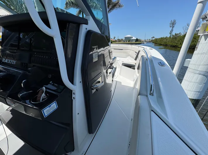  Yacht Photos Pics 2021 Blackfin 272 CC boat, sleek design, docked by a serene waterway.