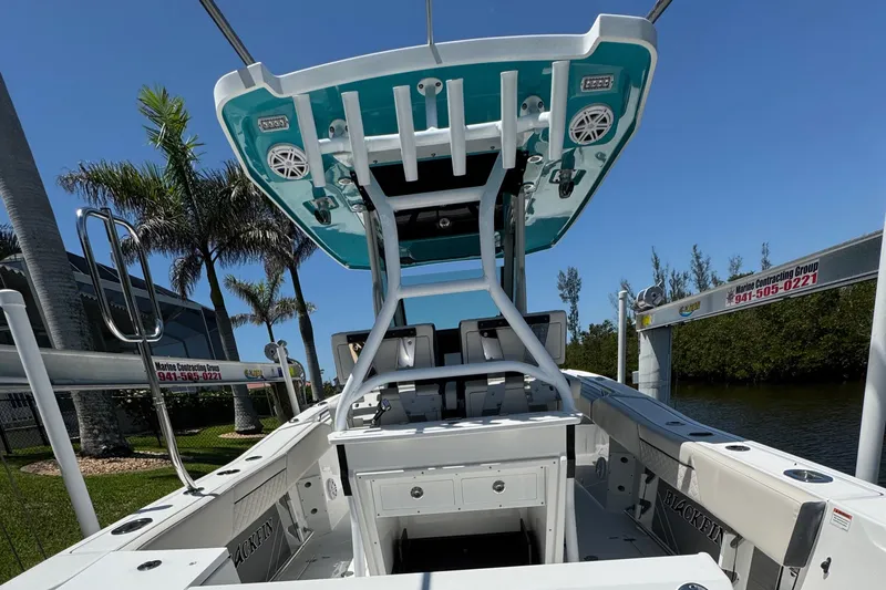  Yacht Photos Pics 2021 Blackfin 272 CC boat with T-top, docked near palm trees and waterway.