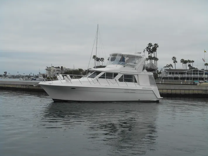 Lucky Yacht Photos Pics 2001 Californian 39 yacht docked in a marina with palm trees in the background.