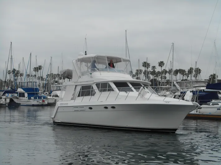 Lucky Yacht Photos Pics 2001 Californian 39 yacht docked in a marina with sailboats and palm trees.