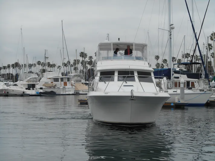 Lucky Yacht Photos Pics 2001 Californian 39 yacht in marina, surrounded by other boats and palm trees.