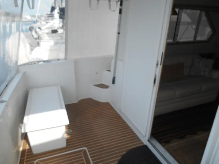 Lucky Yacht Photos Pics Interior view of a 2001 Californian 39 yacht with wooden flooring and seating area.