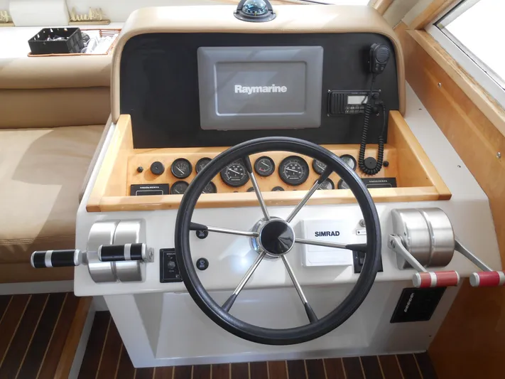 Lucky Yacht Photos Pics Helm of 2001 Californian 39 boat with Raymarine navigation system and steering wheel.