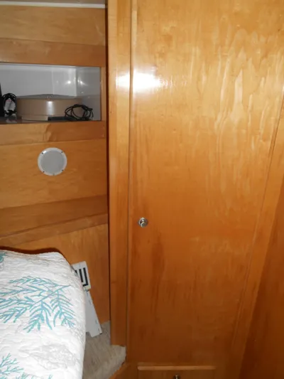 Lucky Yacht Photos Pics Wooden interior of a 2001 Californian 39 boat with storage and bedding.