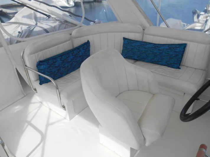 Lucky Yacht Photos Pics White seating area on a 2001 Californian 39 boat with blue cushions.