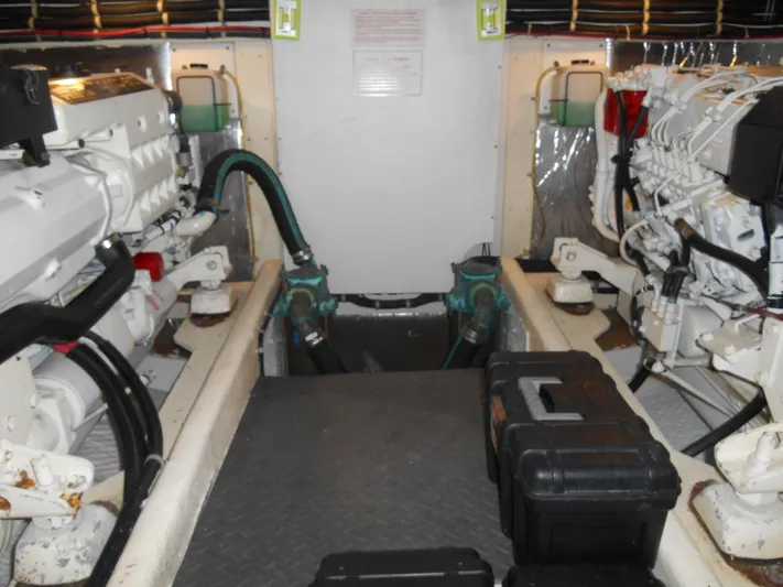 Lucky Yacht Photos Pics Engine room of a 2001 Californian 39 boat, featuring dual engines and toolboxes.