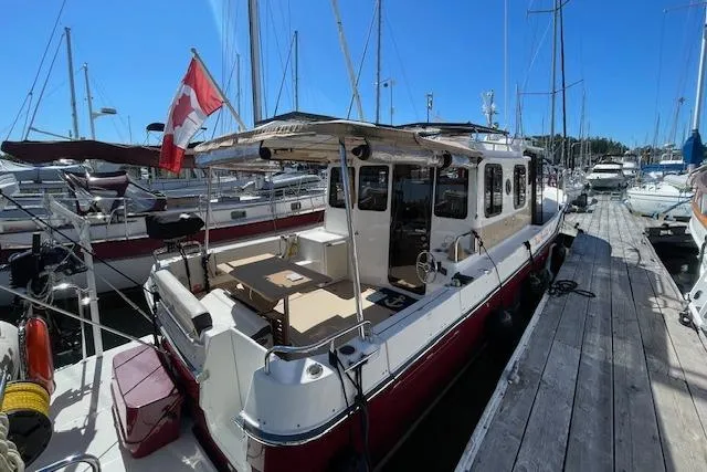  Yacht Photos Pics 2017 Ranger Tugs R-31 S docked, featuring spacious deck and Canadian flag.
