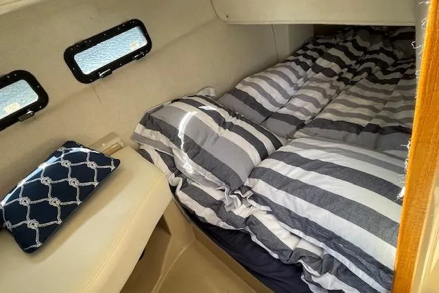  Yacht Photos Pics Cozy cabin interior of 2017 Ranger Tugs R-31 S with striped bedding.