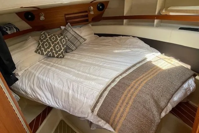  Yacht Photos Pics Cozy cabin interior of 2017 Ranger Tugs R-31 S with comfortable bedding and pillows.