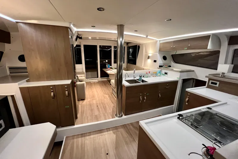 Tamboo Yacht Photos Pics Luxurious interior of 2023 Bali 4.2 yacht with modern kitchen and wooden finishes.
