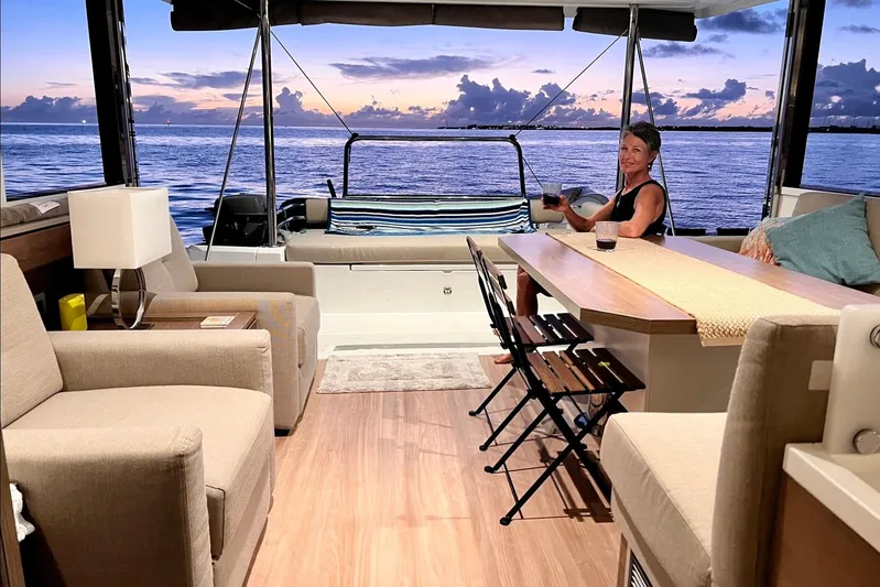 Tamboo Yacht Photos Pics Luxurious Bali 4.2 yacht interior with ocean view, featuring comfortable seating and a dining area.