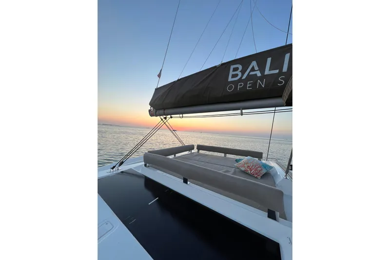 Tamboo Yacht Photos Pics 2023 Bali 4.2 yacht at sunset, featuring open deck and comfortable seating.