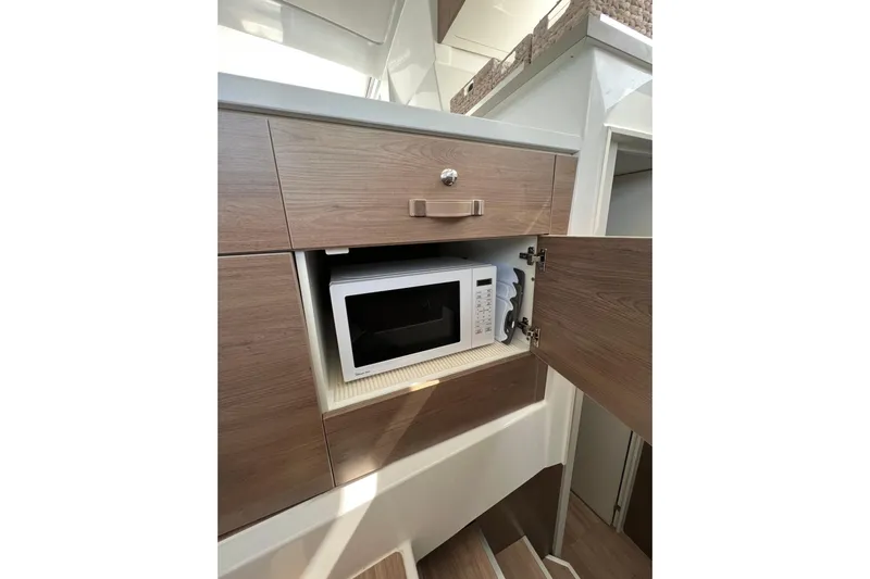 Tamboo Yacht Photos Pics Modern kitchen cabinet with built-in microwave on Bali 4.2, 2023 model.