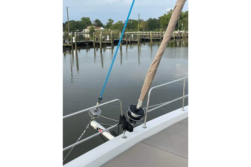 Tamboo Yacht Photos Pics 2023 Bali 4.2 yacht deck with rigging, docked by calm waters.