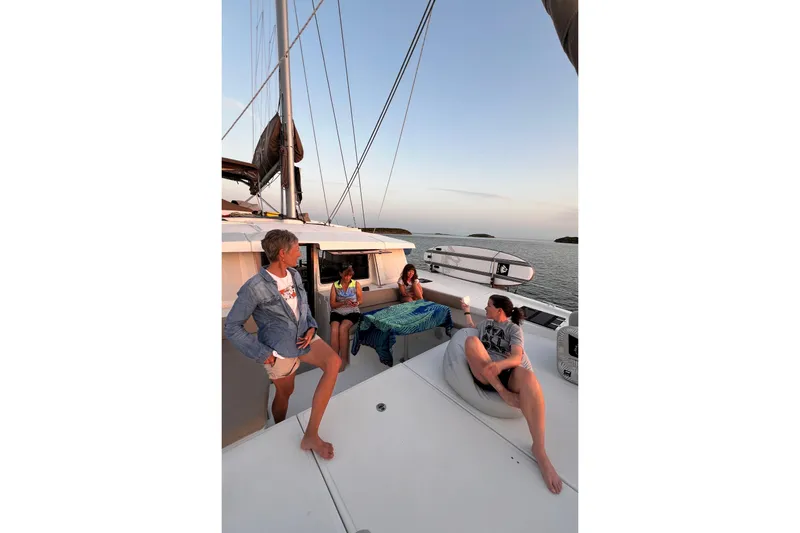 Tamboo Yacht Photos Pics People relaxing on a Bali 4.2 yacht at sunset.