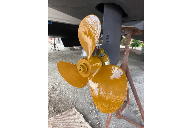 Tamboo Yacht Photos Pics Golden propeller of a 2023 Bali 4.2 boat, displayed on a stand.