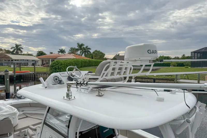  Yacht Photos Pics 2023 Sportsman Open 322 Center Console boat with Garmin radar, docked under cloudy skies.