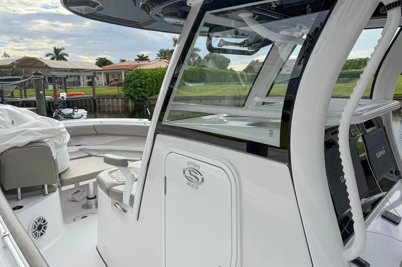  Yacht Photos Pics 2023 Sportsman Open 322 Center Console boat docked, featuring sleek design and modern equipment.