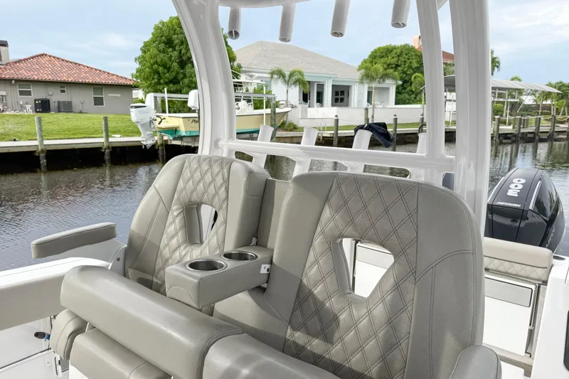  Yacht Photos Pics 2023 Sportsman Open 322 Center Console boat with luxurious seating and waterfront view.