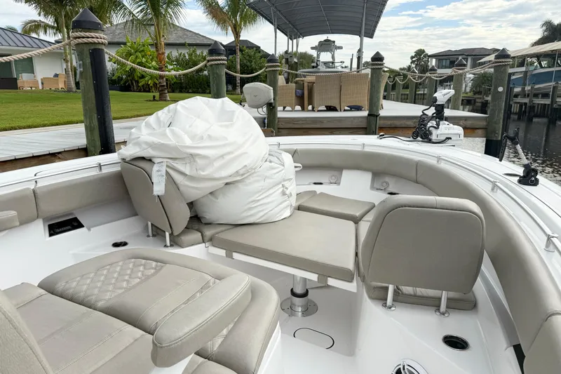  Yacht Photos Pics 2023 Sportsman Open 322 Center Console boat interior with seating and dock view.