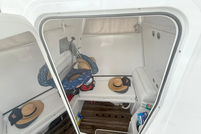 Yacht Photos Pics 2023 Sportsman Open 322 Center Console cabin interior with hats and accessories.