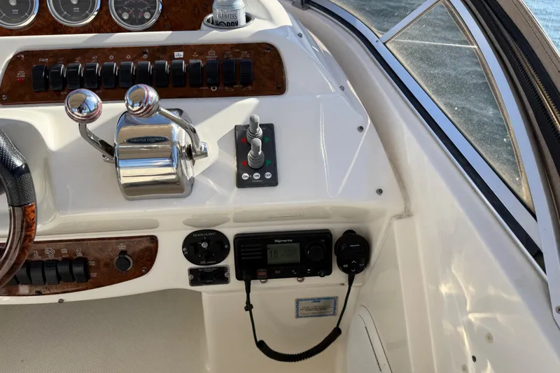  Yacht Photos Pics 2004 Meridian 411 Sedan helm with throttle controls and navigation instruments.