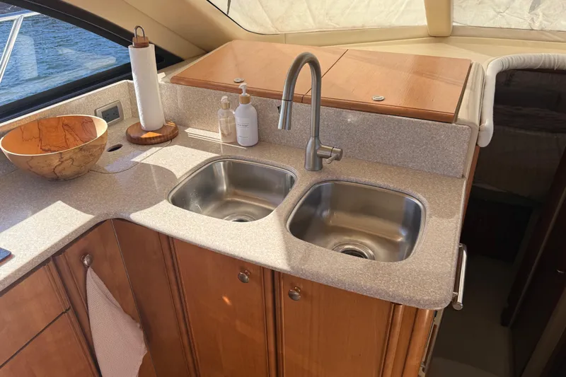  Yacht Photos Pics Luxurious kitchen area in a 2004 Meridian 411 Sedan yacht with dual sinks.