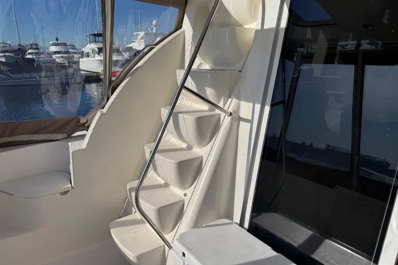  Yacht Photos Pics Staircase on a 2004 Meridian 411 Sedan yacht with marina view.