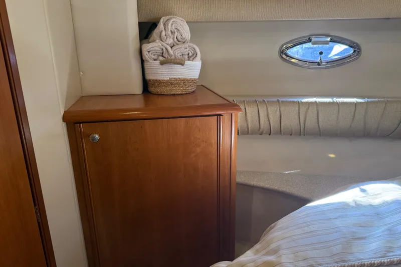  Yacht Photos Pics Interior of 2004 Meridian 411 Sedan with wooden cabinet and porthole window.