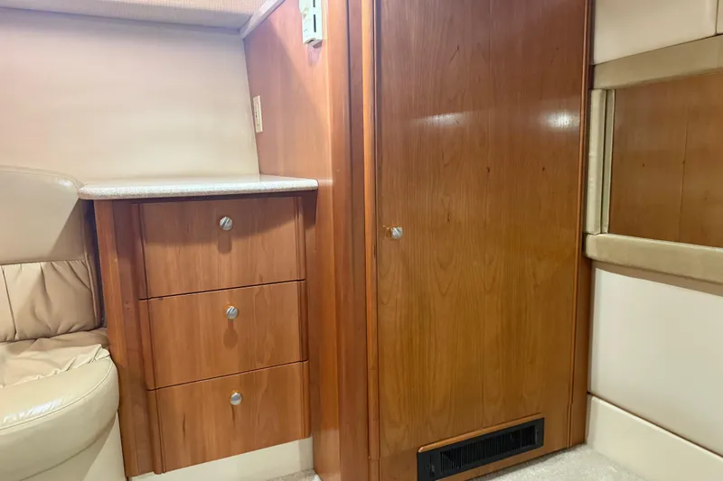  Yacht Photos Pics Interior of 2004 Meridian 411 Sedan with wooden cabinetry and beige seating.