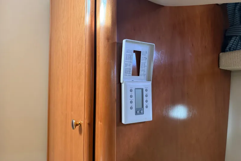  Yacht Photos Pics Thermostat on wooden panel inside 2004 Meridian 411 Sedan yacht interior.
