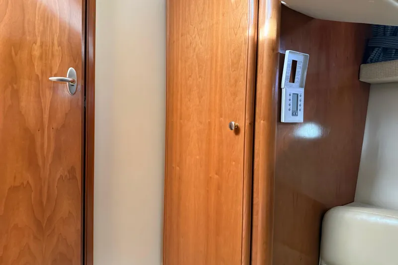  Yacht Photos Pics Interior of 2004 Meridian 411 Sedan with wooden cabinetry and control panel.