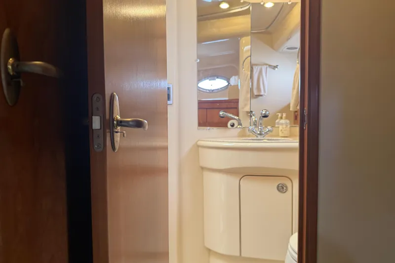  Yacht Photos Pics Bathroom interior of 2004 Meridian 411 Sedan yacht, featuring sink and mirror.