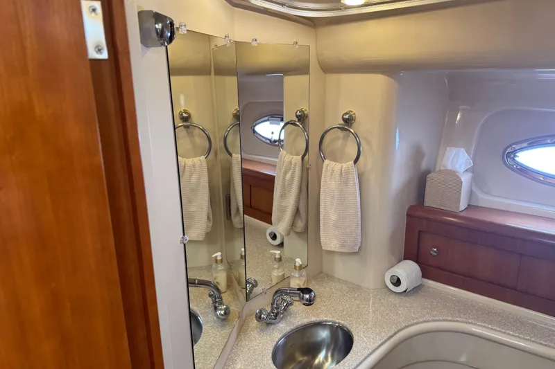  Yacht Photos Pics Luxurious bathroom in 2004 Meridian 411 Sedan yacht with mirror, sink, and towel.