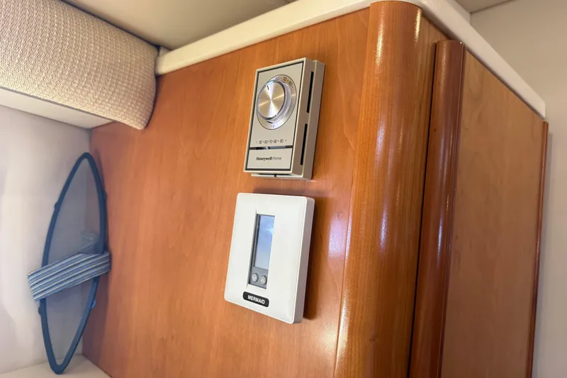  Yacht Photos Pics 2004 Meridian 411 Sedan interior with Honeywell and Mermaid control panels.