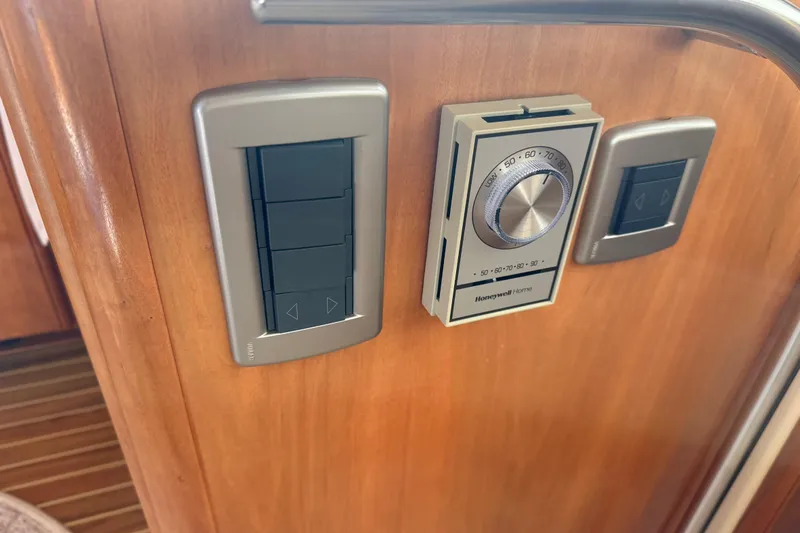  Yacht Photos Pics Control panel on 2004 Meridian 411 Sedan yacht with Honeywell thermostat and switches.