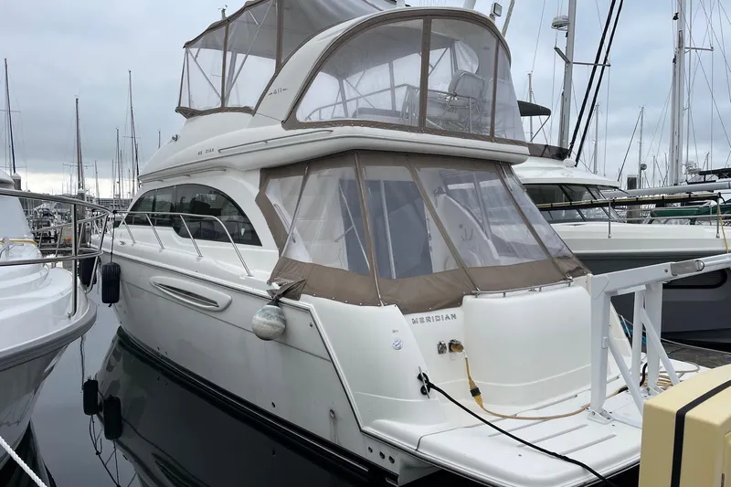  Yacht Photos Pics 2004 Meridian 411 Sedan yacht docked at marina, featuring sleek design and spacious upper deck.
