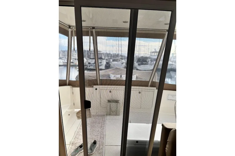  Yacht Photos Pics Interior view of 2004 Meridian 411 Sedan yacht with marina backdrop.