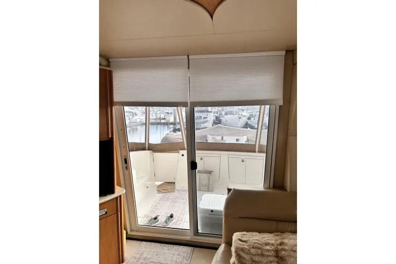  Yacht Photos Pics Interior view of 2004 Meridian 411 Sedan yacht with sliding glass door and marina view.