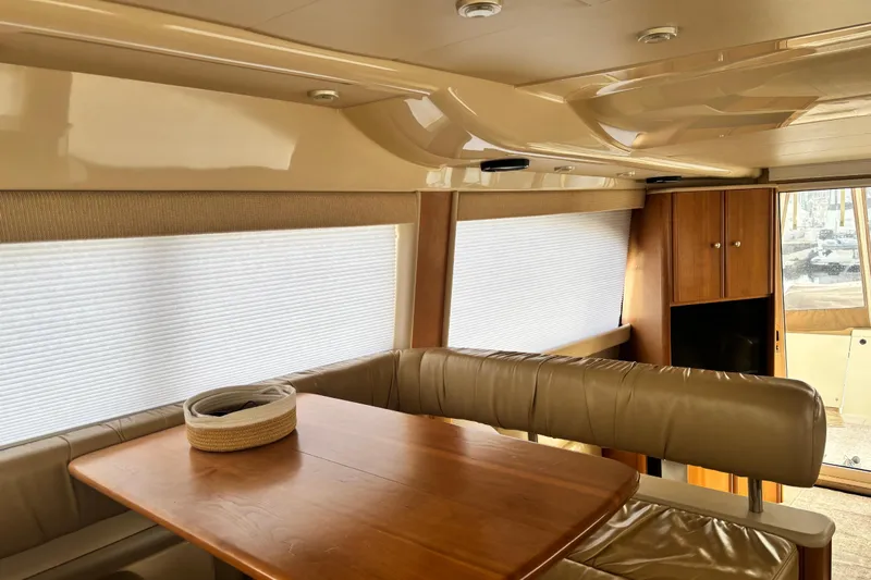  Yacht Photos Pics Interior of 2004 Meridian 411 Sedan yacht with leather seating and wooden table.