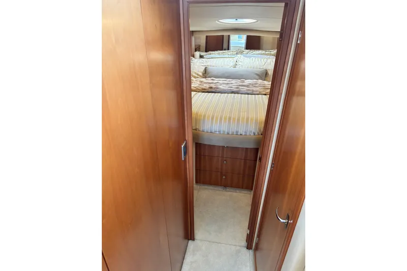  Yacht Photos Pics Interior cabin view of 2004 Meridian 411 Sedan yacht with cozy bed and wooden finish.