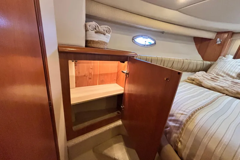  Yacht Photos Pics 2004 Meridian 411 Sedan interior with open wooden cabinet and cozy bed.